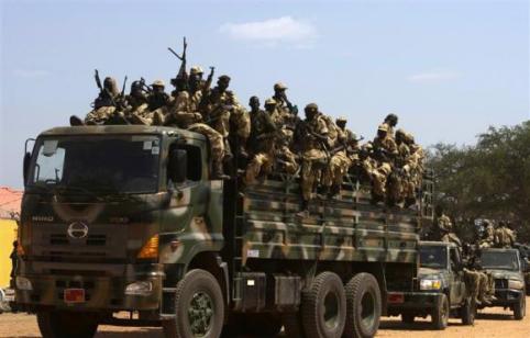 SPLA soldiers drive in a truck in Juba